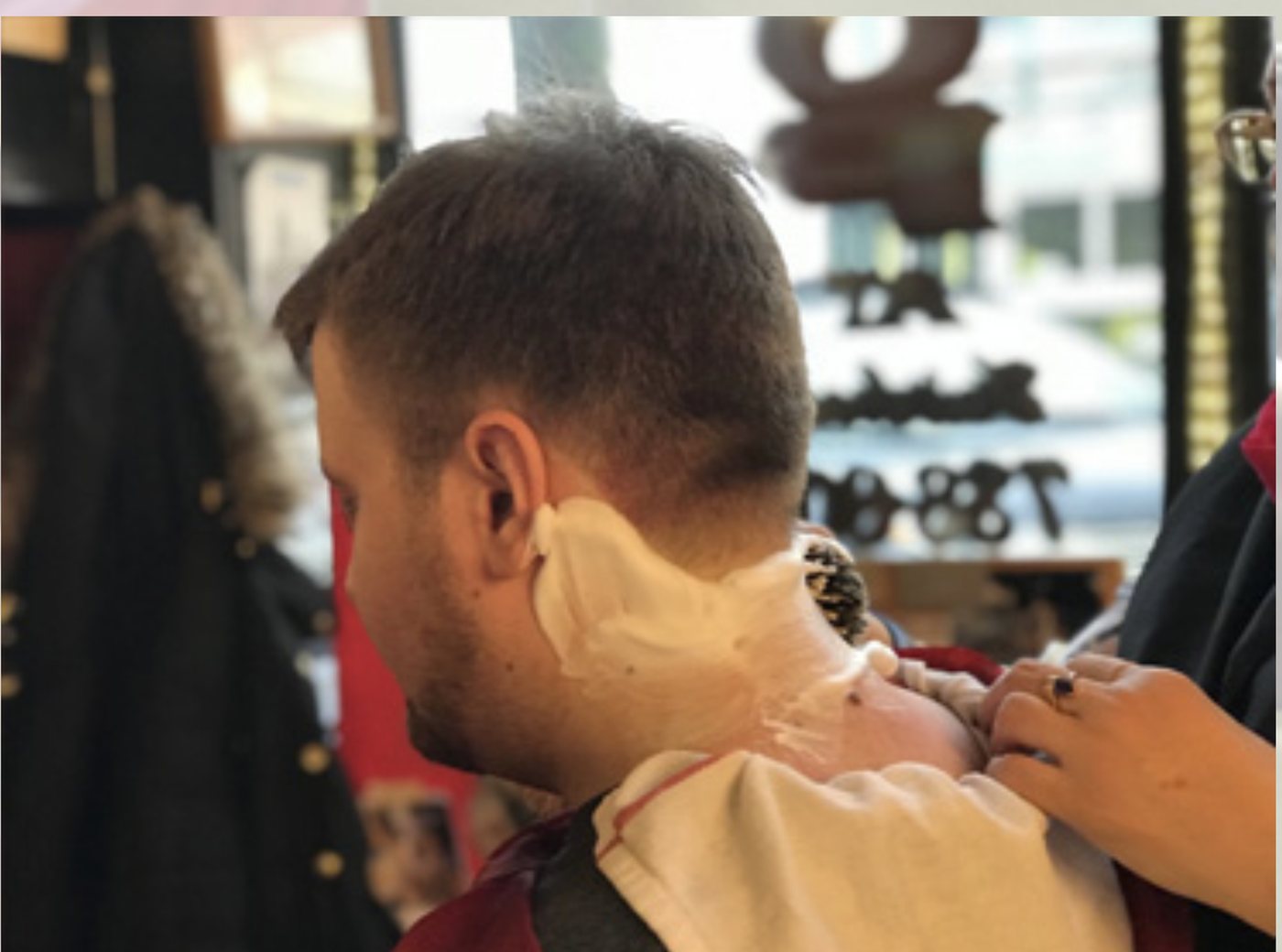 A customer lathered for a straight-razor facial shave